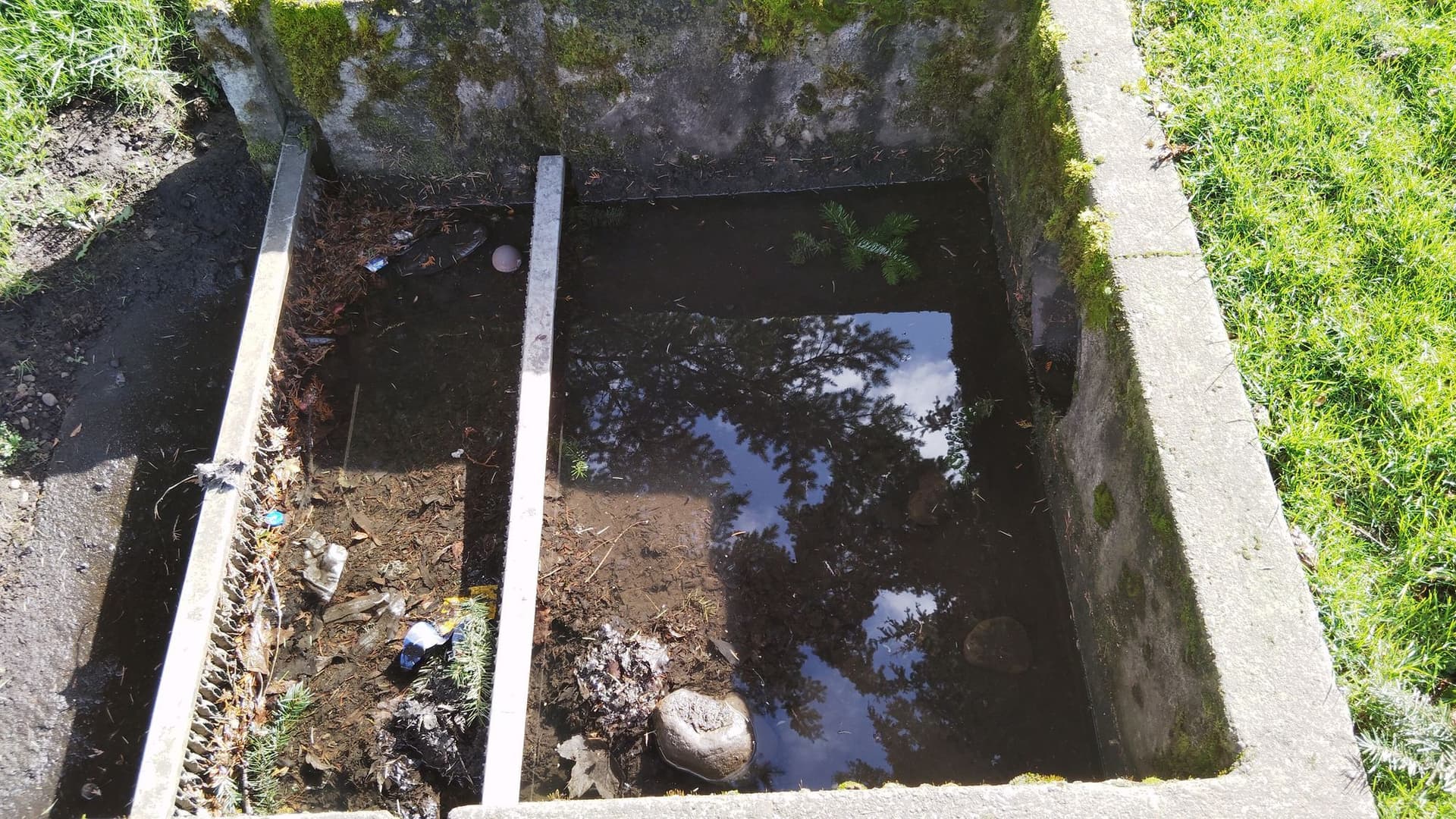 Maintenance crew working on a trash rack structure